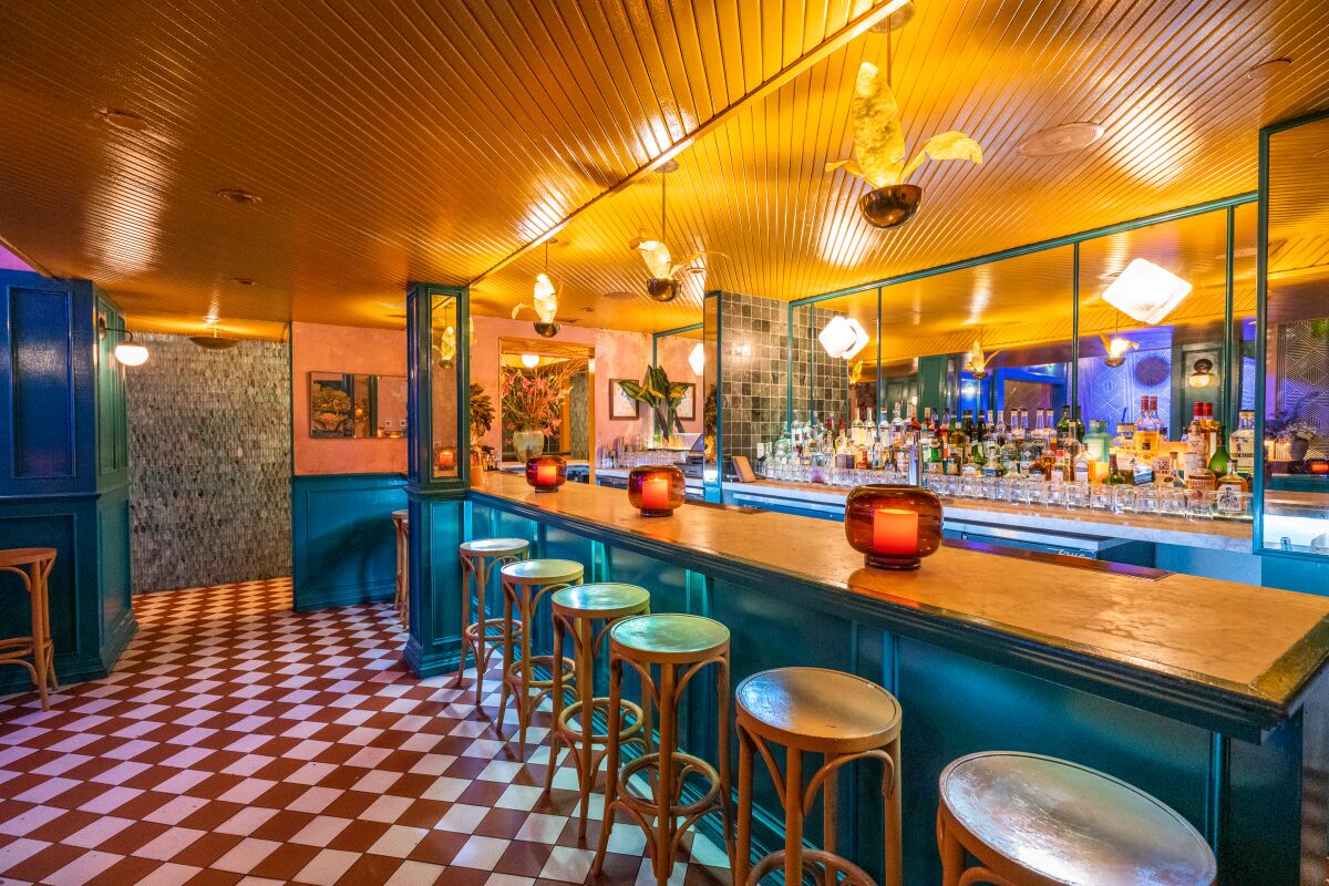 A colorful bar with a red-and-white checkered floor.