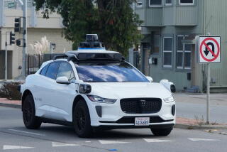 Image 6: A Waymo vehicle drives past a No U-Turn sign in San Bruno, Calif., Tuesday, Sept. 30, 2025. (AP Photo/Jeff Chiu)