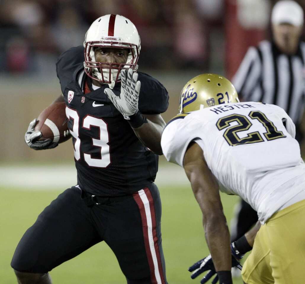 Bruins cornerback Aaron Hester tracks down Cardinal running back Stepfan Taylor in the first half Saturday at Stanford Stadium.
