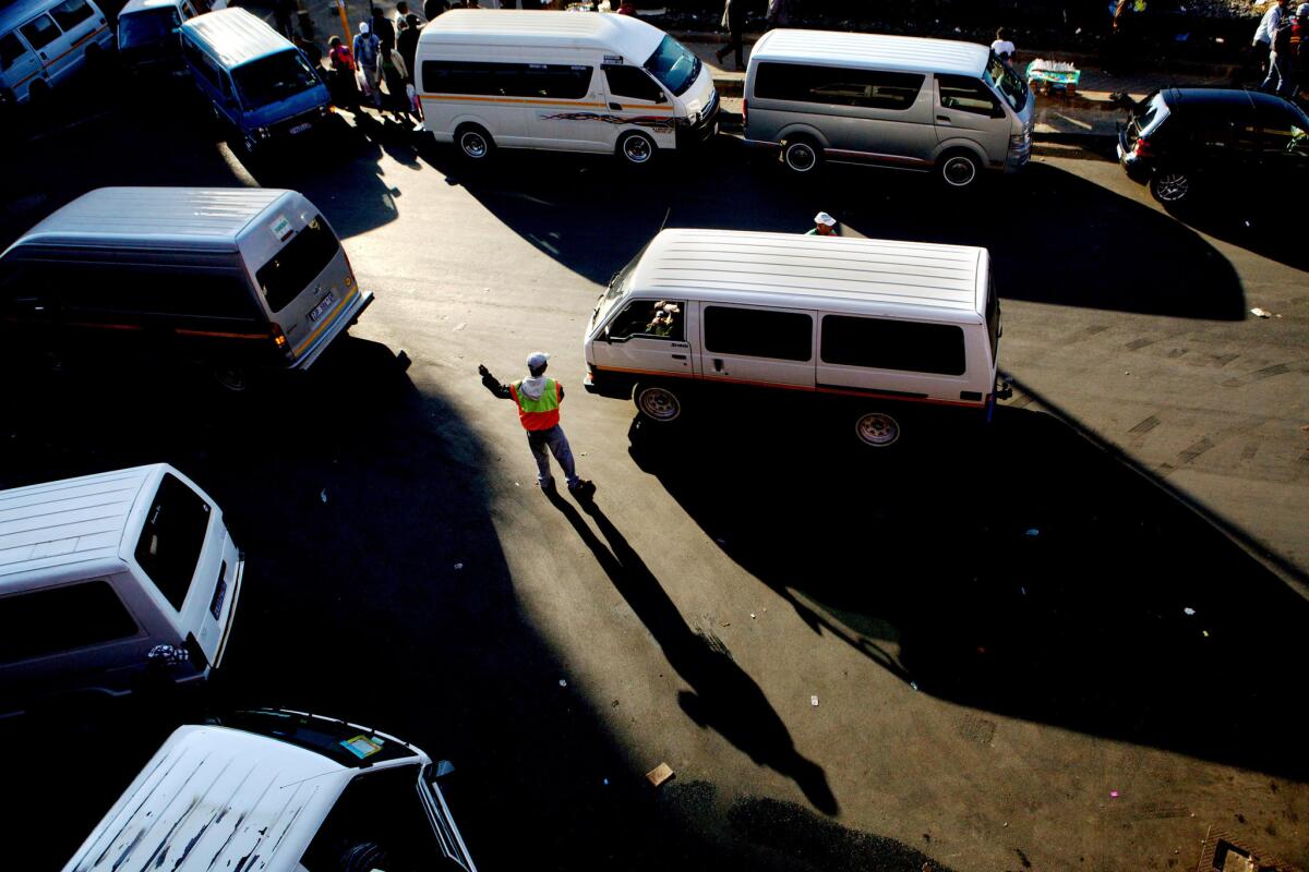 A self-appointed traffic officer who works for tips directs traffic on July 26, 2012, around a busy taxi rank in the Johannesburg, the type of traffic snarl the EcoMobility effort hopes to ease by encouraging bicycle and foot traffic.