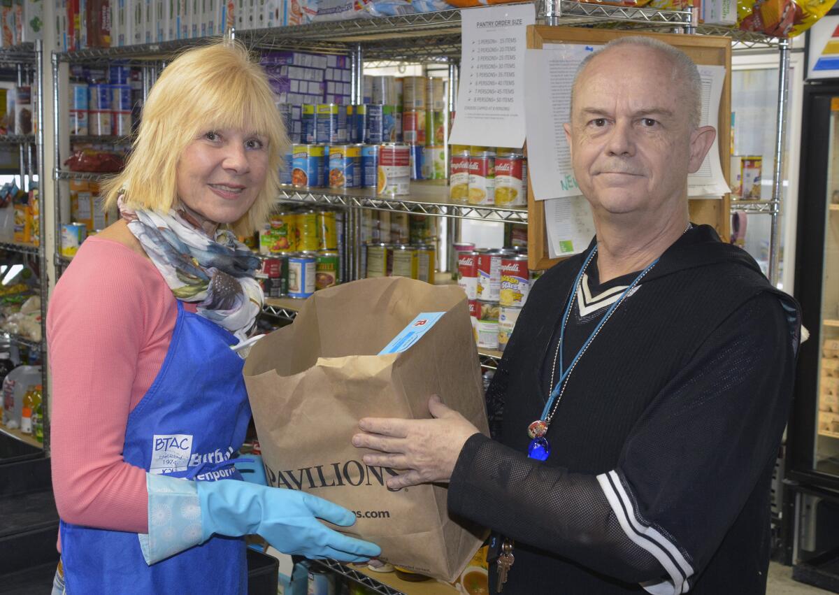 It is business as usual, albeit with a precautionary shift in operations, for longtime BTAC volunteer Bunny Vitale and Edward Stapleton who oversees the pantry and facilities.