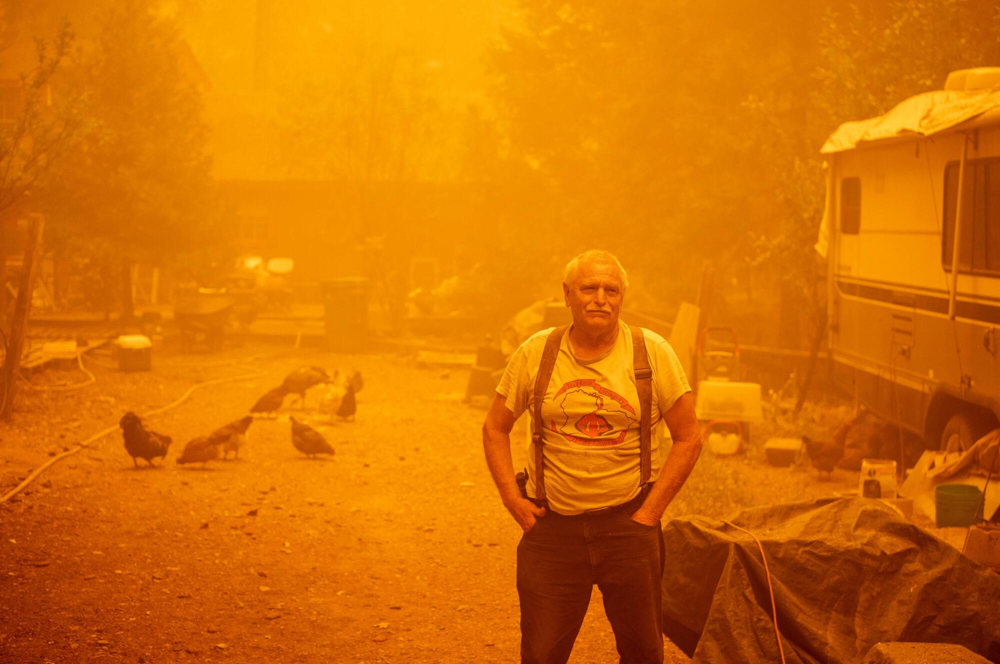 Resident Jon Cappleman looks on as he prepares to defend his home during the Dixie fire in Twain, Calif.
