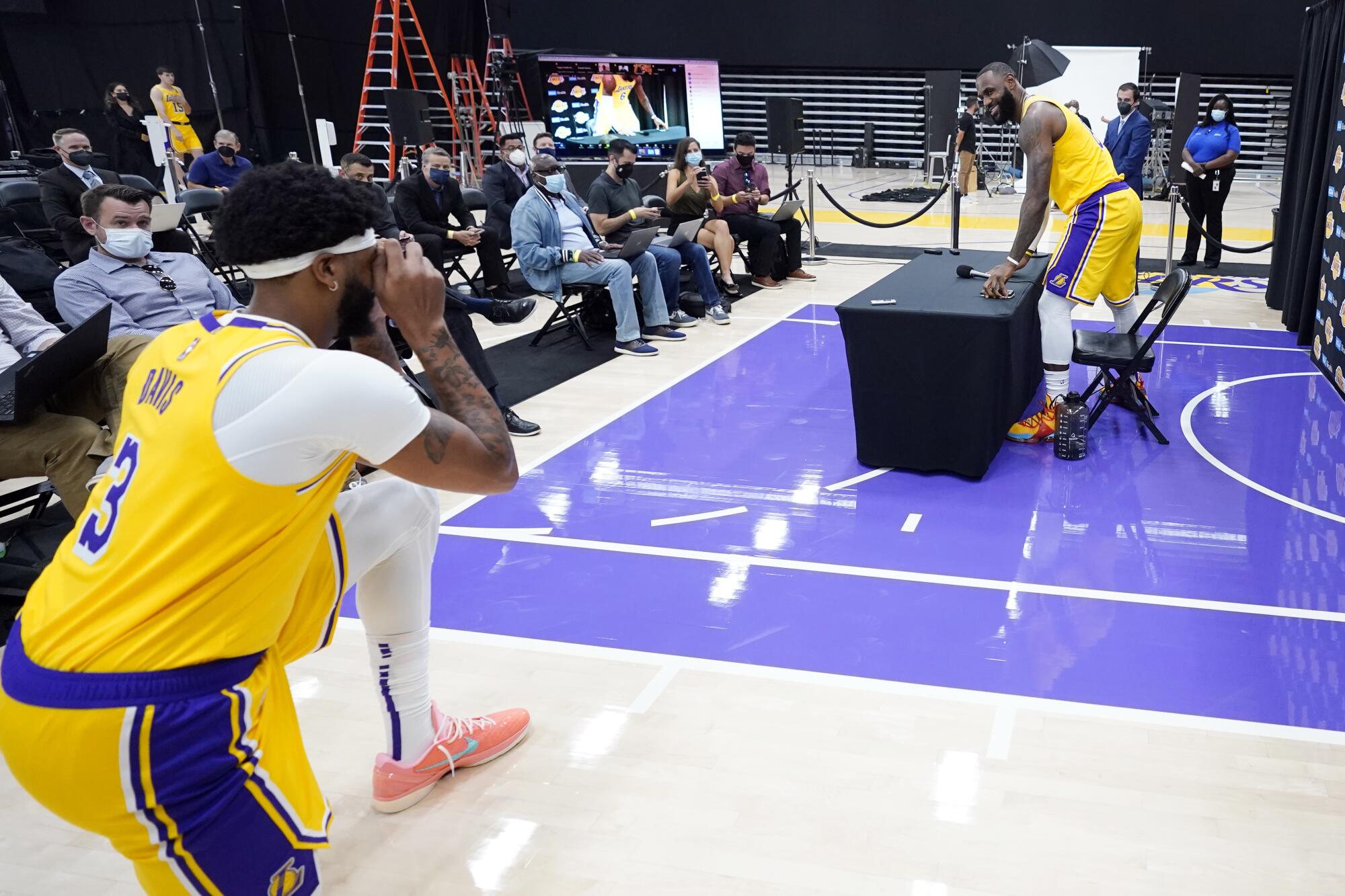 Los Angeles Lakers forward LeBron James, right, has his photo taken by teammate Anthony Davis.