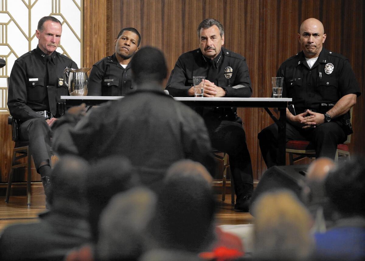 At a community meeting in South L.A. in 2013, from left, LAPD Deputy Chief Bob Green, Commander Bill Scott (now deputy chief), Chief Charlie Beck and Capt. Robert Arcos respond to questions.