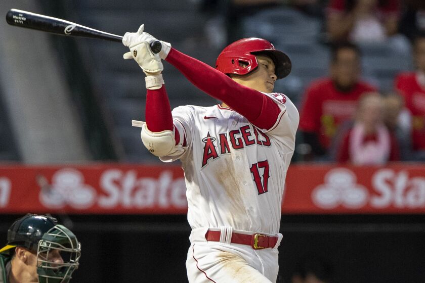 Los Angeles Angels' Shohei Ohtani strikes out with Oakland Athletics catcher Sean Murphy.