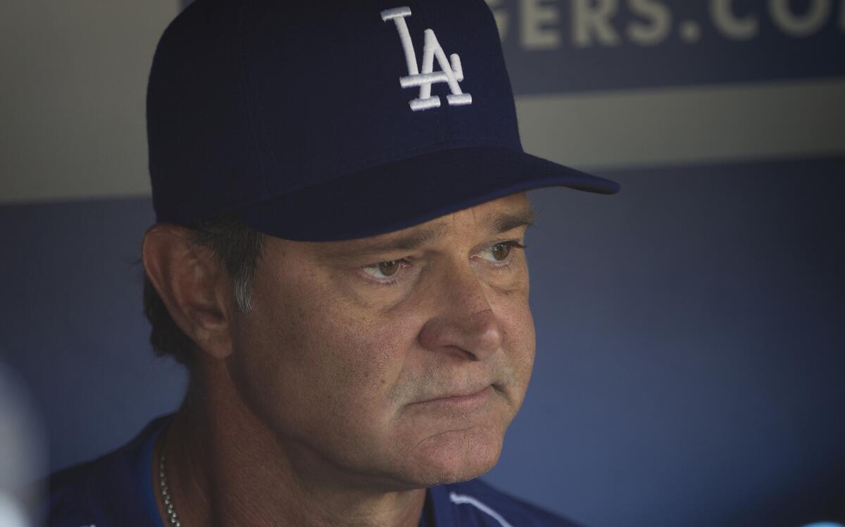 Dodgers Manager Don Mattingly talks to the media in the dugout at Dodger Stadium during a Tuesday workout before the NLDS against the Mets.