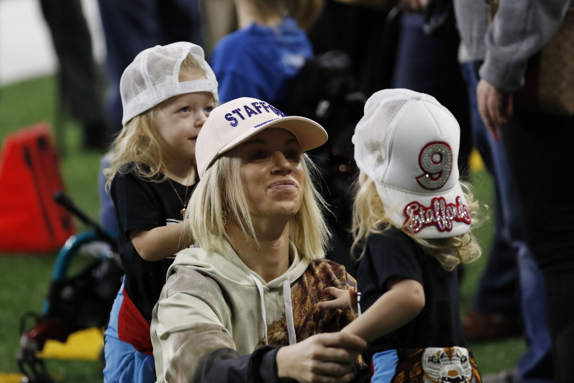 Kelly Stafford, wife of Detroit Lions quarterback Matthew Stafford, talks with twins Chandler and Sawyer before a 2019 game.