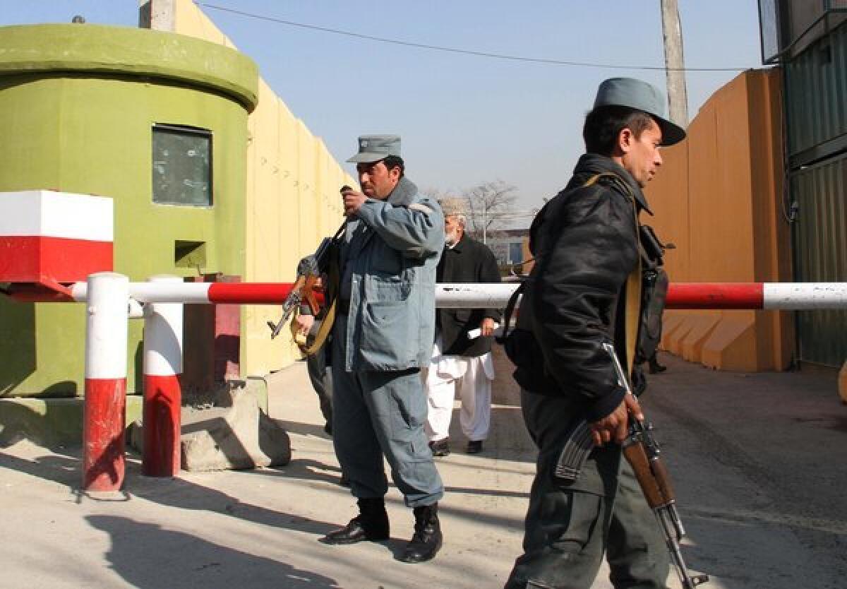 Afghan police stand guard in December outside a compound in Kabul where a U.S. military advisor was shot to death by an Afghan policewoman. Attacks by Afghan servicemen on their NATO colleagues reportedly have accounted for 15 international troop casualties this year and some 15% of all foreign deaths in 2012.