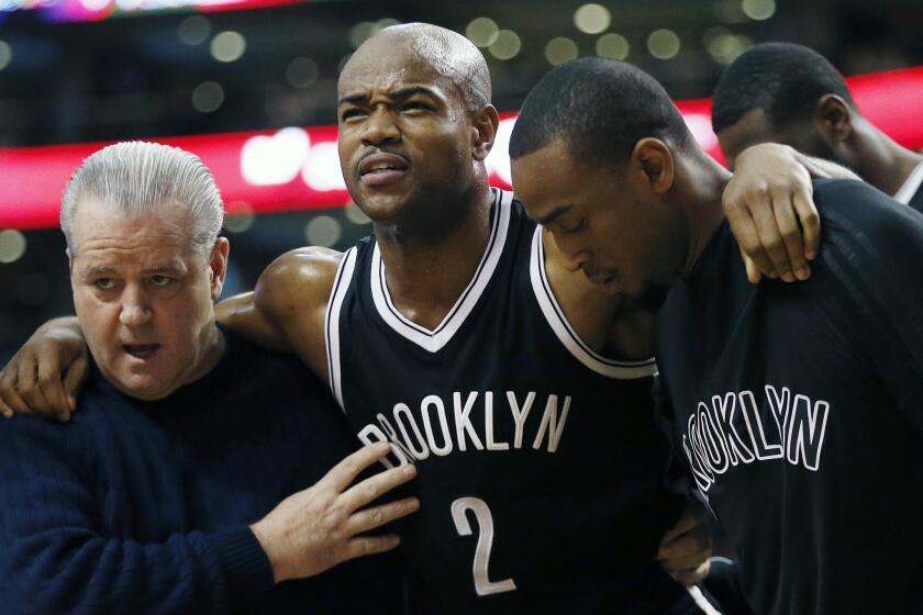Nets guard Jarrett Jack (2) is helped off the court after being injured during the third quarter.