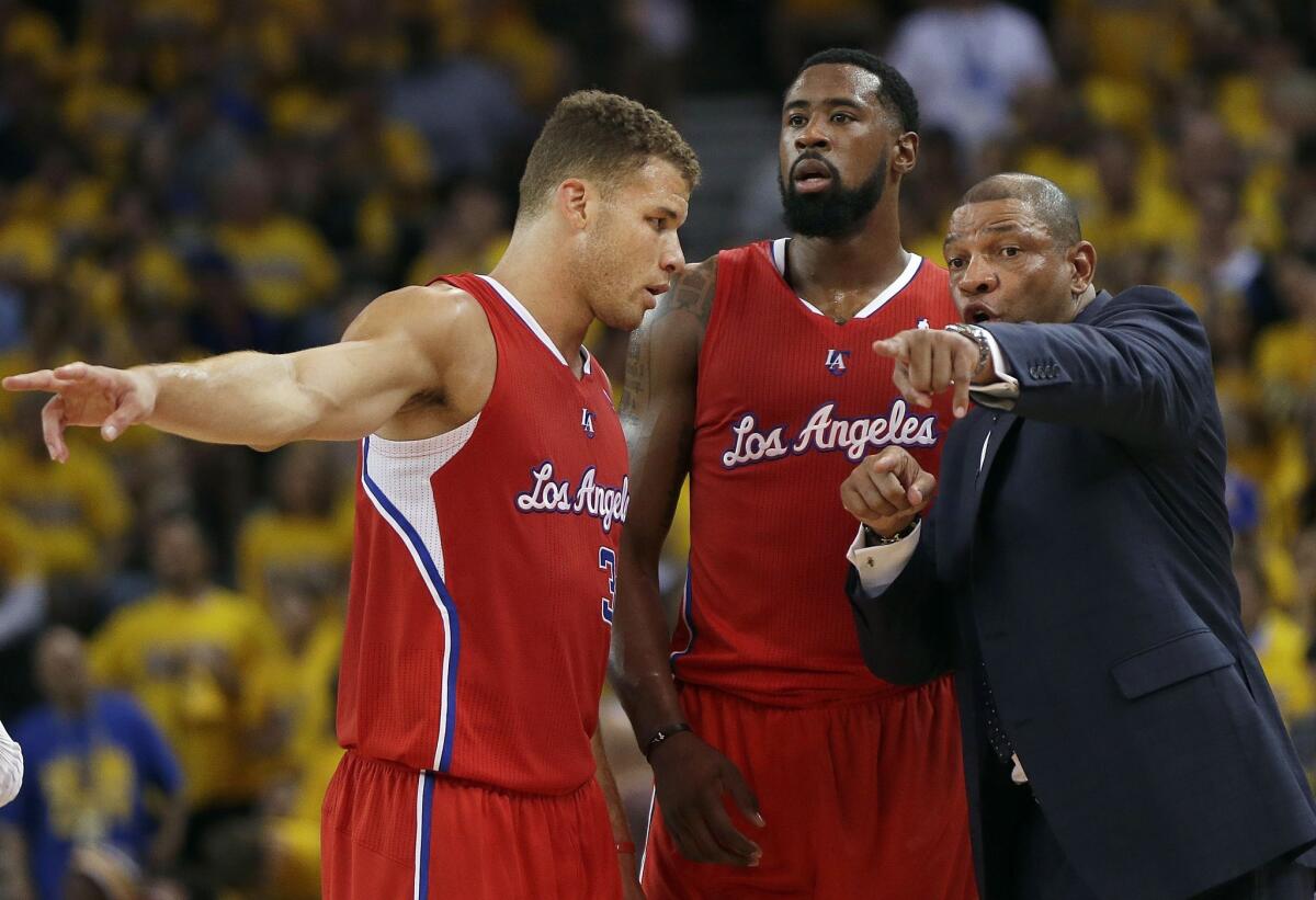 Clippers Coach Doc Rivers discusses strategy with big men Blake Griffin, left, and DeAndre Jordan at May 1st's game.