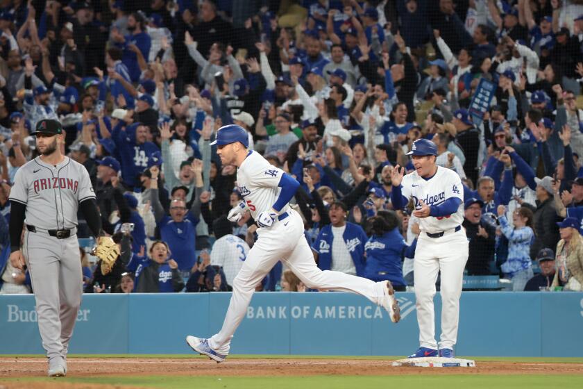 LOS ANGELES, CALIFORNIA May 20, 2024- Dodgers Freddie Freeman hits a grand slam against the Diamondbacks in the third inning at Dodgers Stadium Monday. (Wally Skalij/Los Angeles Times)