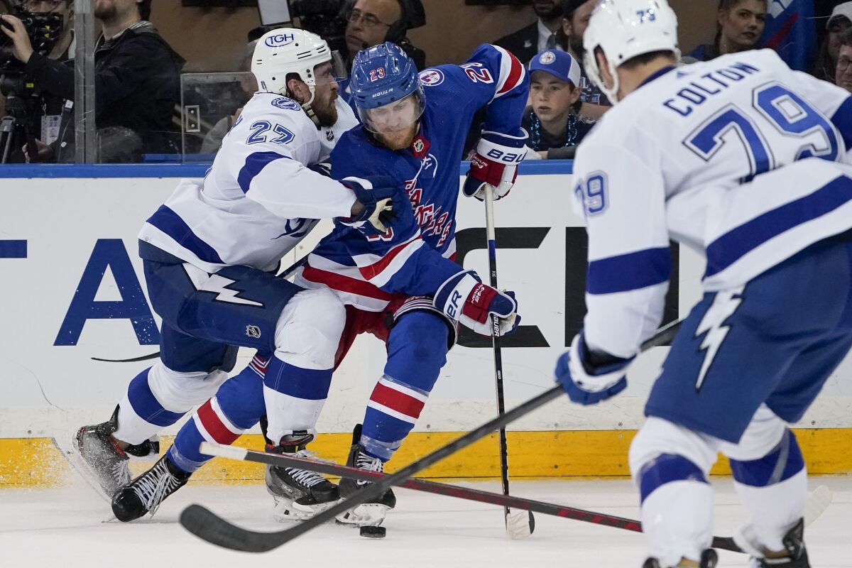 Tampa Bay Lightning defenseman Ryan McDonagh (27) checks New York Rangers defenseman Adam Fox (23) in the second period of Game 2 of the NHL hockey Stanley Cup playoffs Eastern Conference finals, Friday, June 3, 2022, in New York. (AP Photo/John Minchillo)