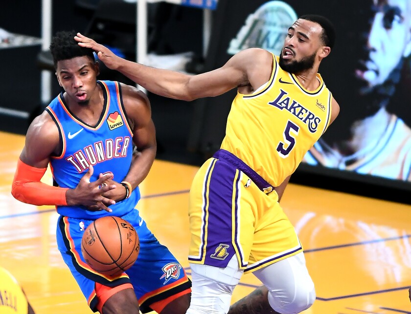 The Lakers' Talen Horton-Tucker tries to prevent the Oklahoma City Thunder's Hamidou Diallo from scoring.