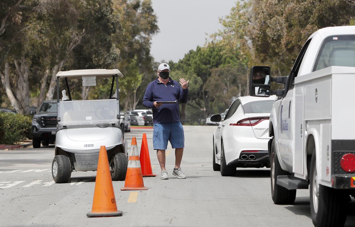 Employee Steve "Gibby" Gibbs allows a guest into the parking lot as he checks on the passengers' tee times at Costa Mesa Country Club on Wednesday.