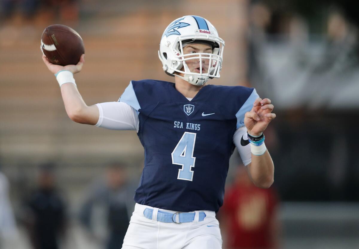 Corona del Mar quarterback Ethan Garbers completes a pass against Downey in the first half of a season opener on Friday at Newport Harbor High.