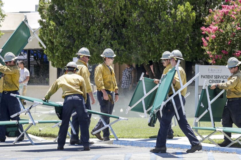 RIDGECREST, CA - JULY 04, 2019 ? Fire fighters placing cots for patients that are being evacuated from Ridgecrest Regional Hospital after city was hit by a 6.4 earthquake Thursday July 04, 2019 morning. (Irfan Khan / Los Angeles Times)