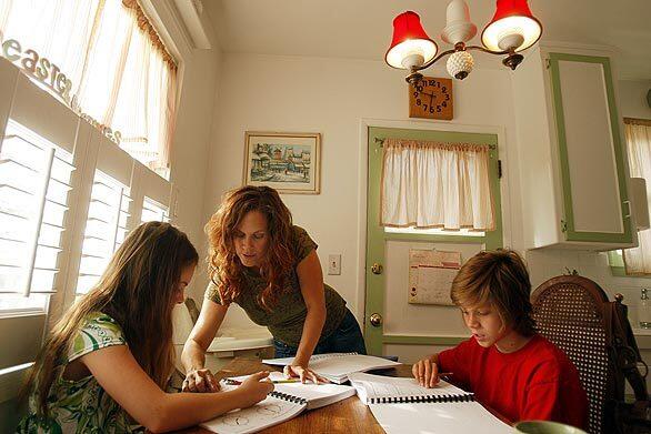 Kym Curto home schools her older children Chamberlain, left, 9, and Caedyn, 13, while also tending to a 3-year-old and 20-month-old. Though the South Bay mother says the hectic arrangement "has its rough days," the ability to give her children a more personal education with a nod to their Christian faith makes the effort all the more worthwhile.