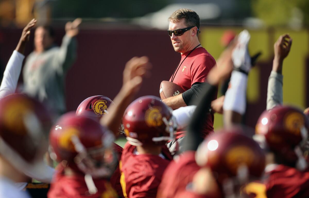 Peter Sirmon helps oversee a practice on Dec. 23 as USC prepared for the Holiday Bowl.