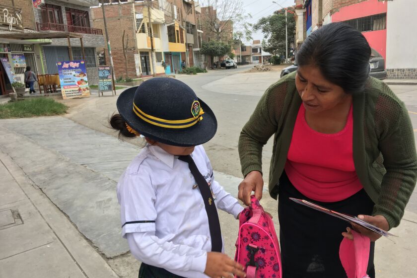 Gloria Basilio, 46, picks up her granddaughter, Nathaniel, 7, from school in Lima’s Puente Piedra district. Basilio is recognized by Peru as a victim of forced sterilization under the government of Alberto Fujimori.