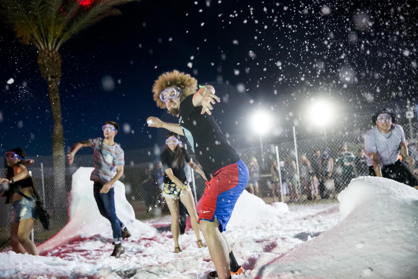 Jimmy Arwood, center and other Coachella festival goers participate in a snowball fight, one of the many activities on the camp site during Week 2 of the Coachella Valley Music and Arts Festival, 2015.