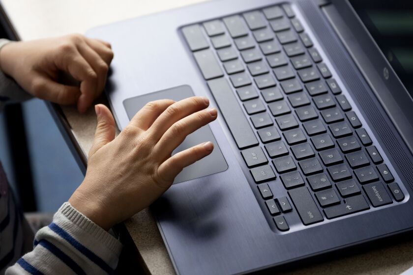 A close-up of a child's hands on a laptop at Roath Park Primary School on June 29, 2020 in Cardiff, Wales. 