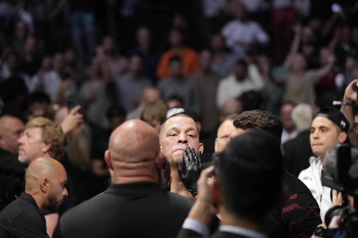 Nate Diaz, center, prepares to Tony F 