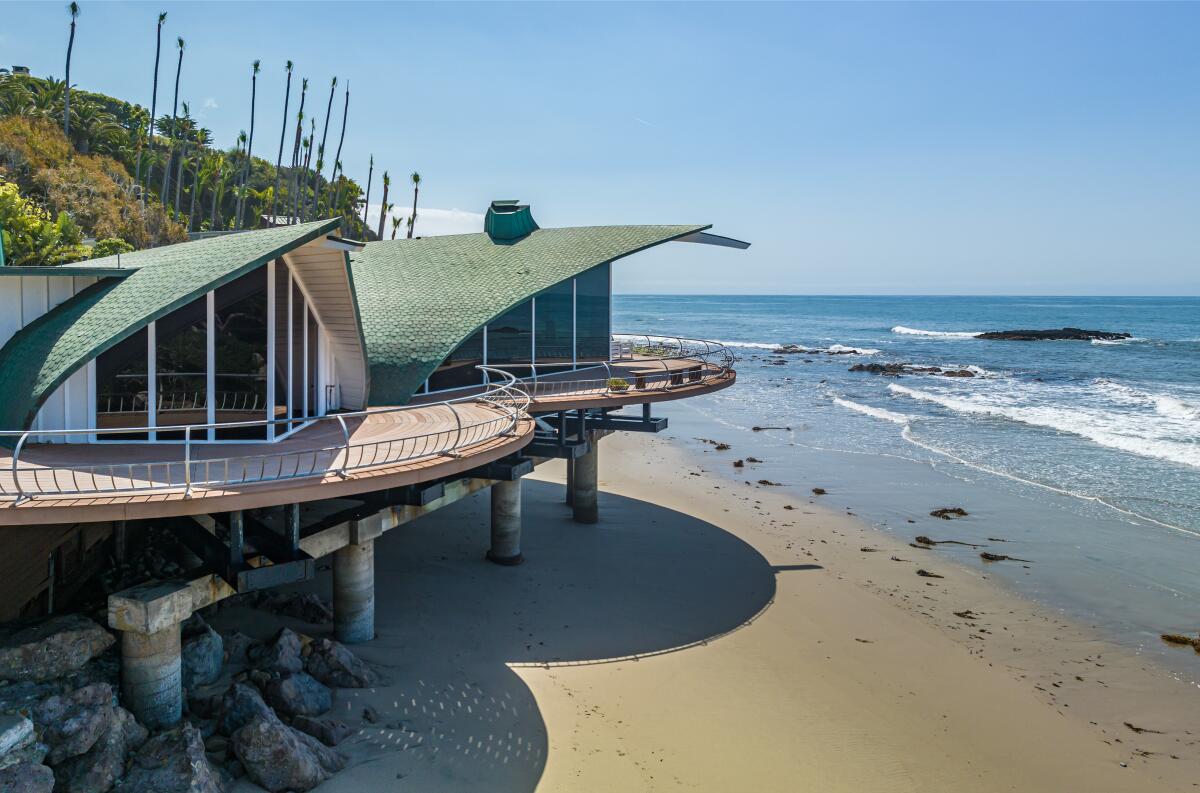 The iconic "Wave House" hovers above the beach in Malibu, curling to resemble the rolling waves beneath it.