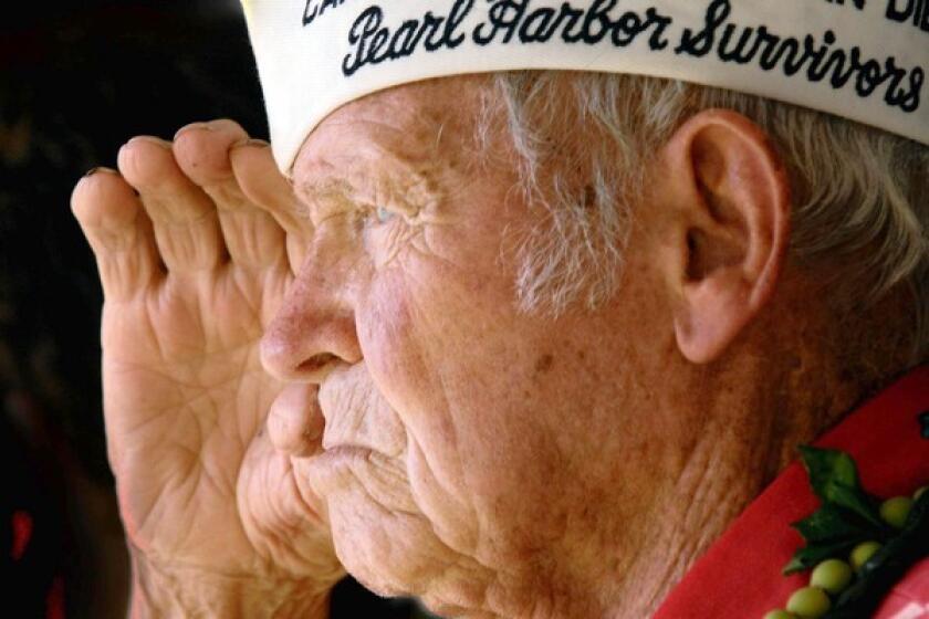 In this Dec. 7, 2006, photo, John Finn salutes at the groundbreaking ceremony for the USS Oklahoma memorial at Pearl Harbor.