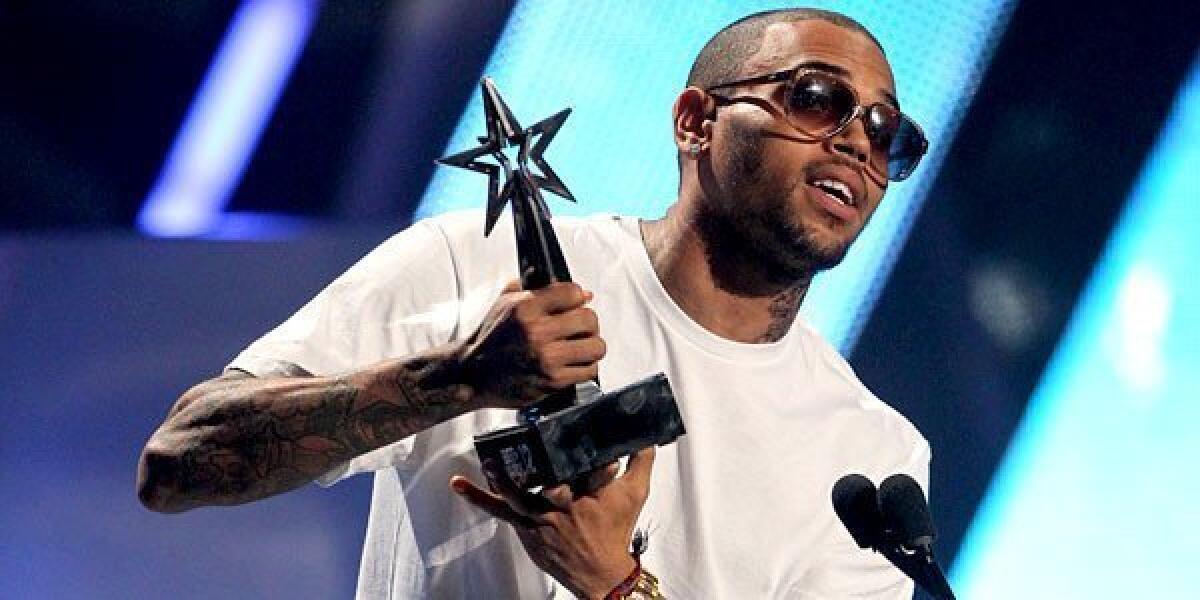 Chris Brown accepts the award for best male R&B; artist at the BET Awards.