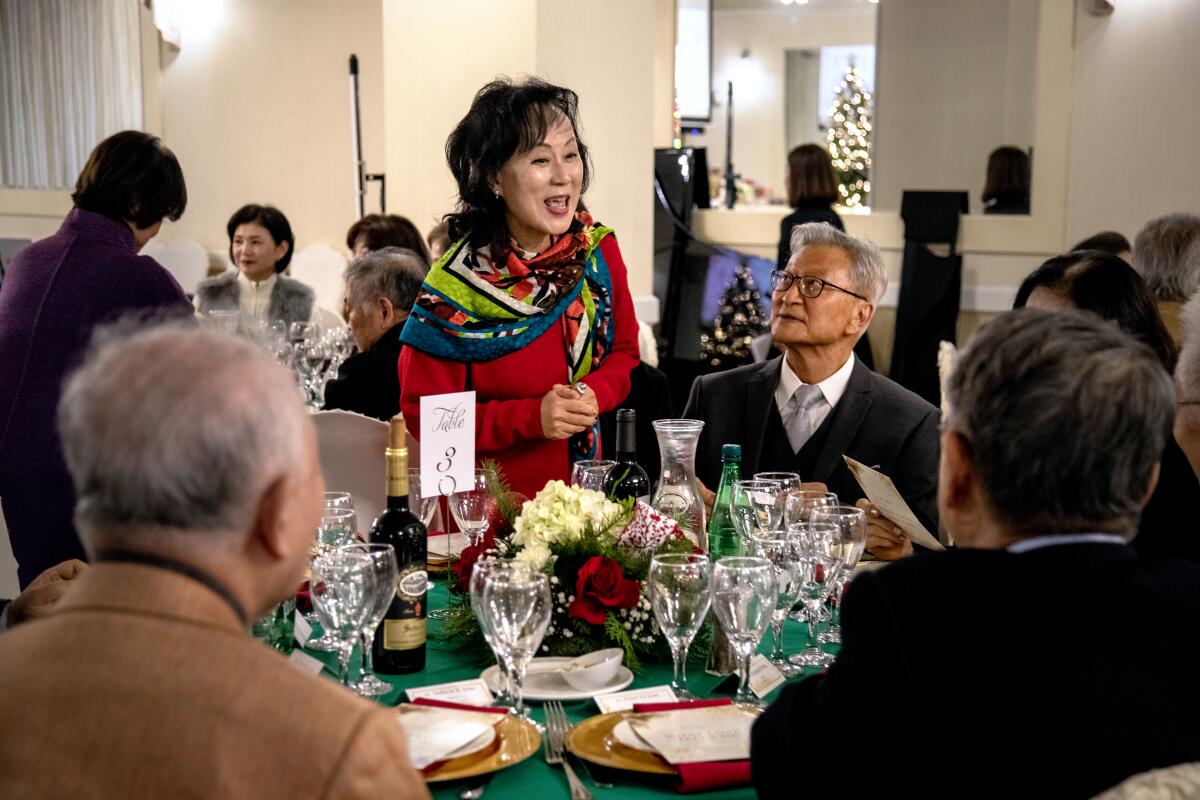 Karin Kim greets alumni and others during the year-end gathering of Seoul Arts High School's L.A. chapter in Koreatown.