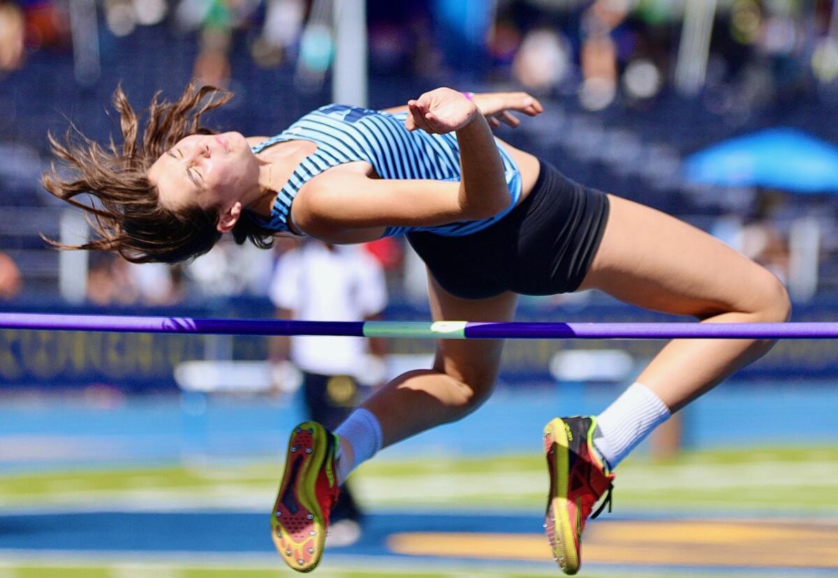 Marshall’s Oleana Taalman Koch clears the bar at 5 feet 2 inches to win the girls' high jump.