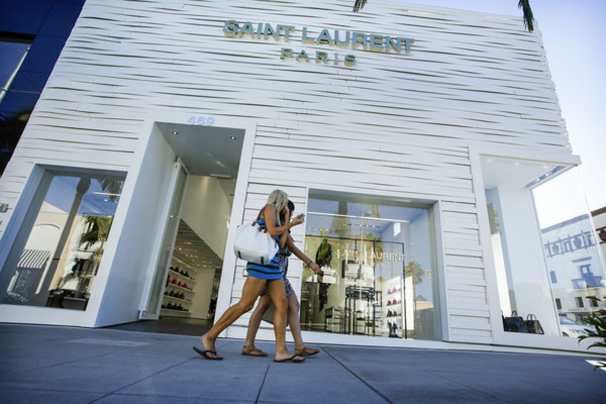 Women walk past Saint Laurent Paris in August. More than $100,000 in merchandise was stolen from the Rodeo Drive boutique, Beverly Hills police say.
