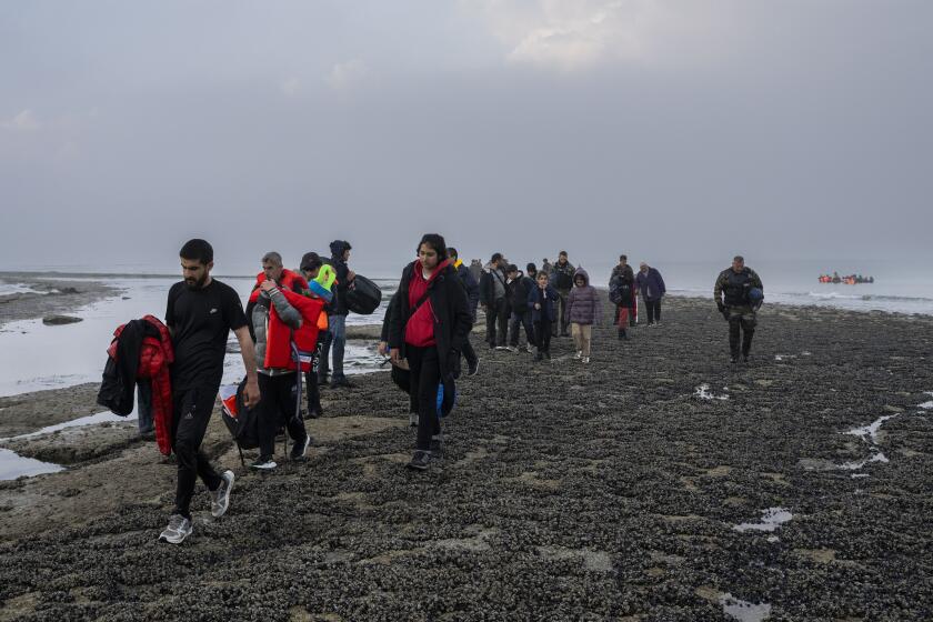A group of Kurdish migrants from Iran and Iraq who failed in their attempt to reach the United Kingdom by boat after being discovered by the police walk back to the town of Ambleteuse, northern France, on Sunday, May 19, 2024. (AP Photo/Bernat Armangue)