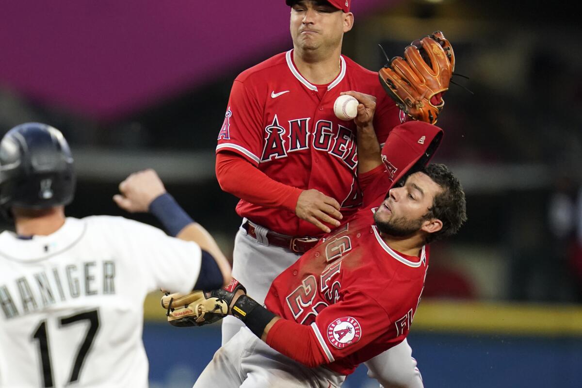 Angels shortstop José Iglesias, lower right, and second baseman David Fletcher collide.
