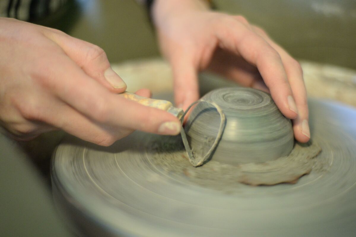 Staff writer Sara Butler attempts making a ceramic on pottery wheel