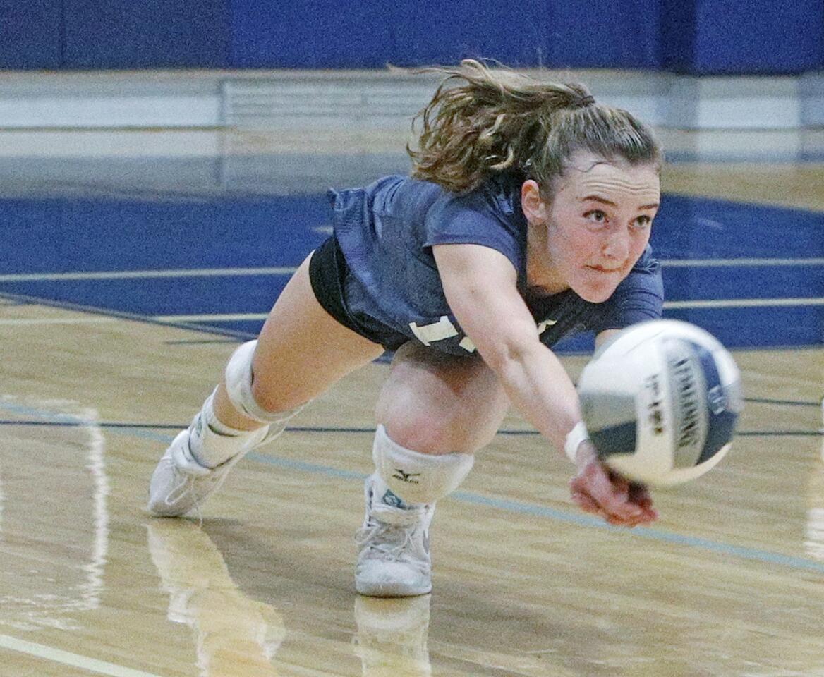 Flintridge Prep's Courtney Johnson dives to the floor to keep a kill attempt by Providence in play in a Prep League girls volleyball match at Flintridge Prep High School on Tuesday, August 28, 2018. Providence is new to the Prep League, and this was their first match.
