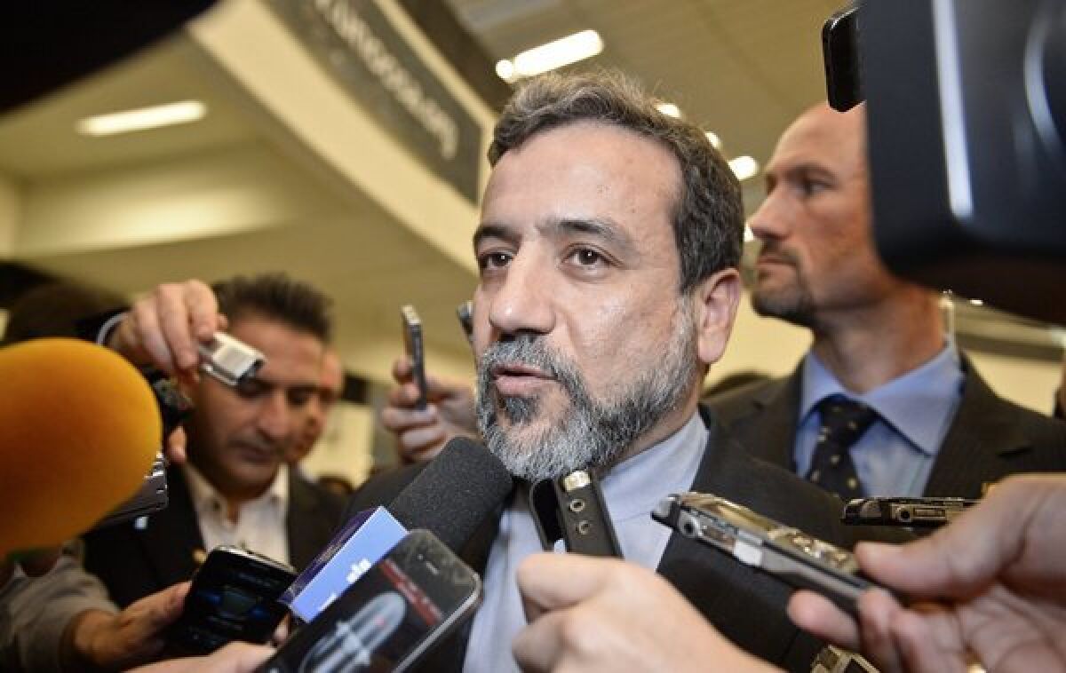 Iranian nuclear negotiator Abbas Araqchi talks to reporters after a meeting with International Atomic Energy Agency officials in Vienna.