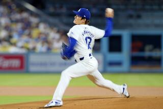 Dodgers starting pitcher Yoshinobu Yamamoto throws to the plate during the team's loss to the Cubs Tuesday 