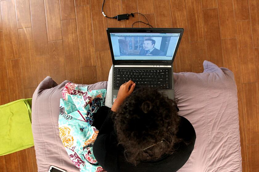 A USC student watches an episode of a television show on her laptop.
