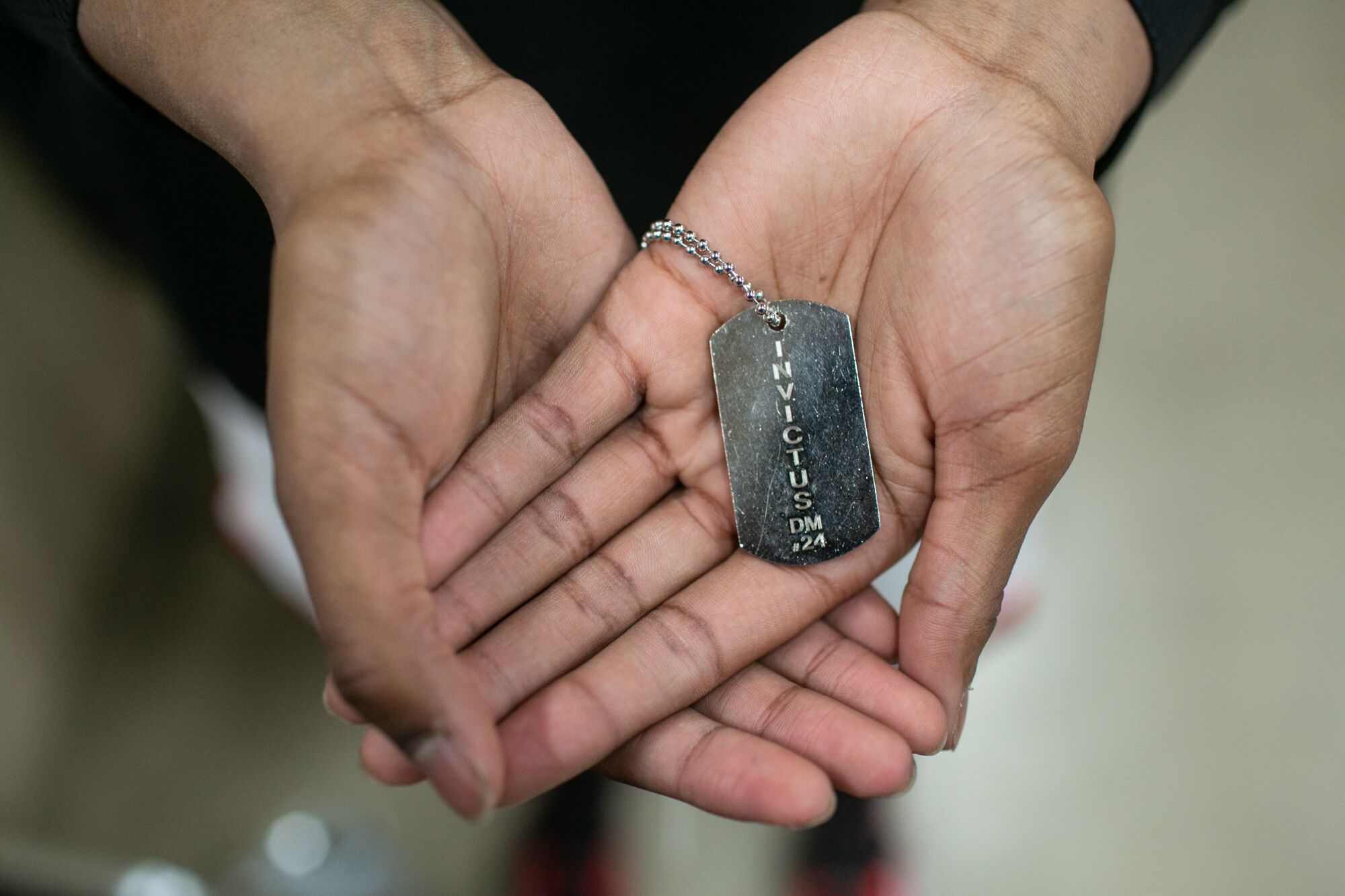 Etiwanda team captain Daisia Mitchell holds her custom silver dog tag that is inscribed with "Invictus."