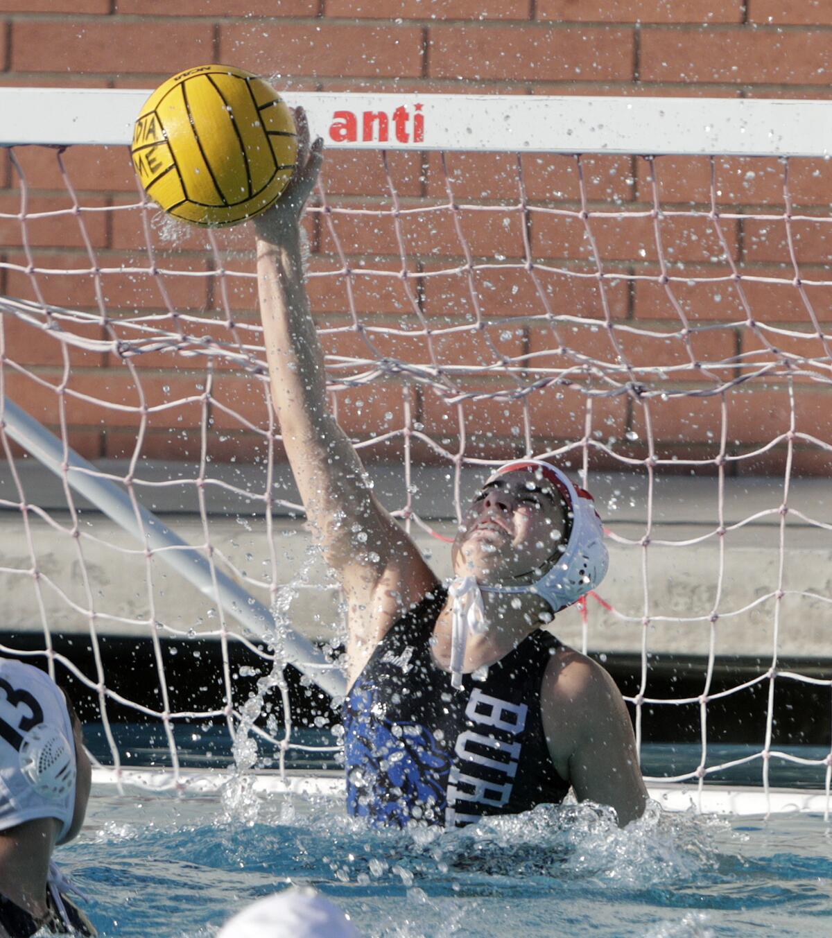 Burbank's goalie Jenny Stepanyan stops an Arcadia shot from scoring in a Pacific League girls' water polo match at Arcadia High School on Thursday, January 9, 2020.