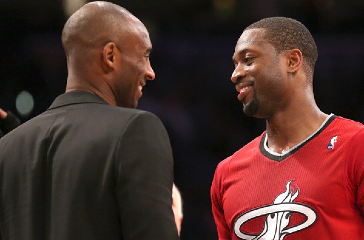 The Lakers' Kobe Bryant and Miami's Dwyane Wade chat before a Dec. 25, 2013, game at Staples Center.