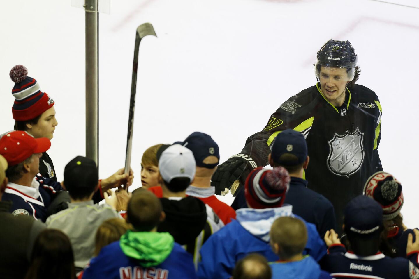 Blue Jackets center Ryan Johansen of Team Foligno gives his stick to a fan after earning MVP honors, as voted on by fans via Twitter, for the NHL All-Star game on Sunday.