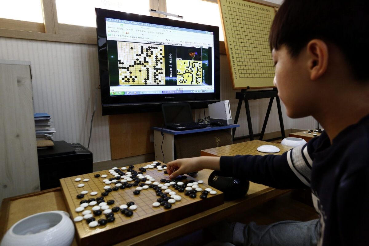 A South Korean elementary school student watches a live stream of the match as human Go champion Lee Sedol battles AlphaGo.