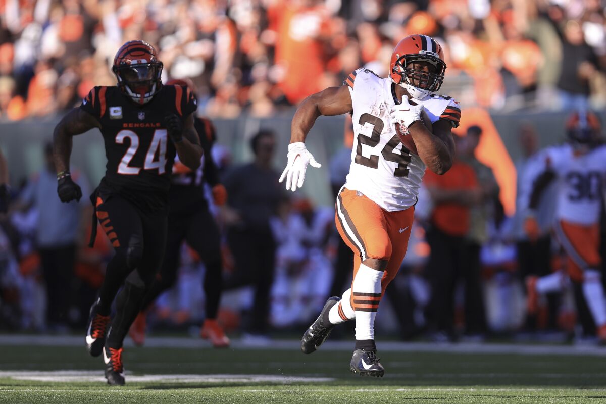 Cleveland Browns' Nick Chubb (24) runs past Cincinnati Bengals' Vonn Bell (24) for a touchdown during the second half of an NFL football game, Sunday, Nov. 7, 2021, in Cincinnati. (AP Photo/Aaron Doster)