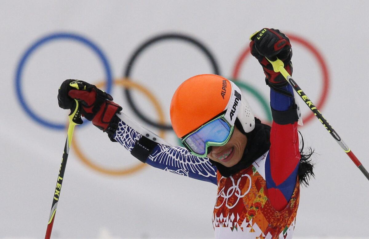 Violinist pop star Vanessa-Mae - competing as Vanessa Vanakorn - celebrates after completing the first run of the women's giant slalom at the Sochi 2014 Winter Olympics.