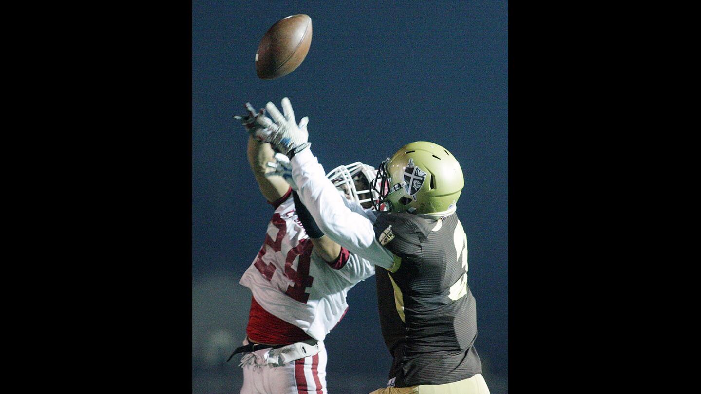 St. Francis' Daniel Scott and La Serna's Anthony Garcia battle for the ball in the air in a CIF Southern Section Southeast Division semifinal football playoff game at St. Francis High School on Friday, November 27, 2015. St. Francis lead at halftime 10-7.