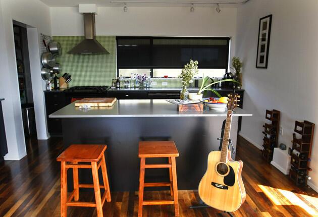 Half of Weibrecht's kitchen, which was based on an IKEA plan. A contractor built the cabinetry, but Russell bought the cabinet doors from IKEA. The counter is a light Caesarstone quartz, and the appliances are black. "All very minimalist," Weibrecht said.