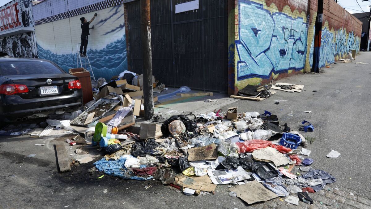 A pile of trash sits uncollected in Los Angeles' Fashion District. Local businesses say they fear a typhus outbreak will spread because the city hasn't picked up trash in the area.