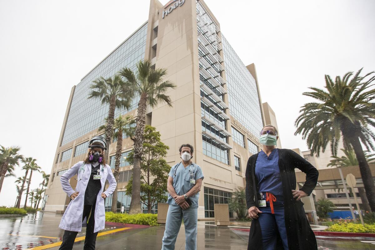 Dr. Aviva Alyeshmerni, left, Dr. Steven Abelowitz, center, and Dr. Gigi Kroll stand in front of Hoag Memorial Hospital Presbyterian, where the doctors have called for a mandatory mask policy for everyone interacting with patients at the Newport Beach hospital.